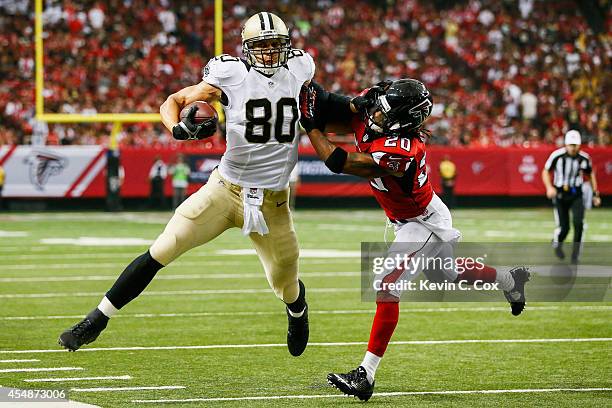 Jimmy Graham of the New Orleans Saints is tackleds by Dwight Lowery of the Atlanta Falcons in the first half against the New Orleans Saints at the...