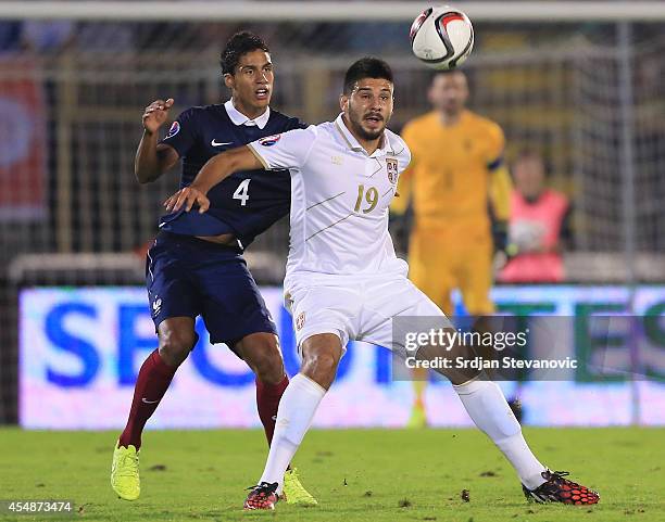 Aleksandar Mitrovic of Serbia in action against Raphael Varane of France during the International friendly match between Serbia and France at the...