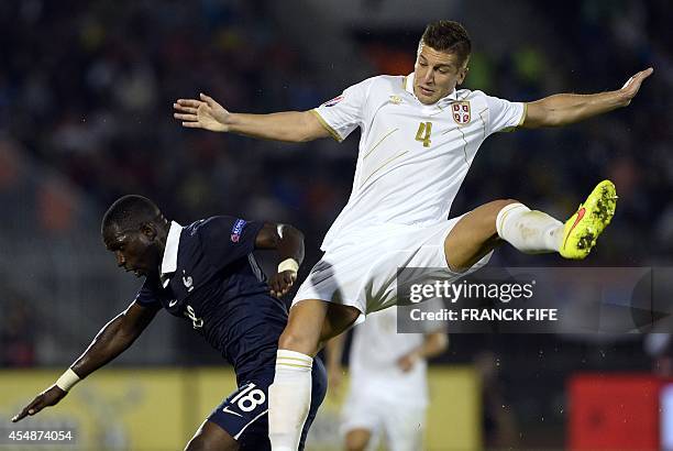 France's midfielder Moussa Sissoko and Serbia's defender Matija Nastasic jump during the international friendly football match Serbia vs France on...