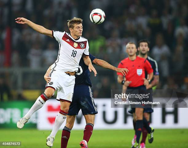 Toni Kroos of Germany jumps for a header during the EURO 2016 Qualifier match between Germany and Scotland at Signal Iduna Park on September 7, 2014...