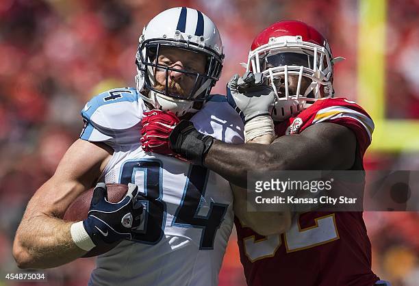 Tennessee Titans tight end Taylor Thompson fights off the tackle attempt of Kansas City Chiefs linebacker James-Michael Johnson during the third...