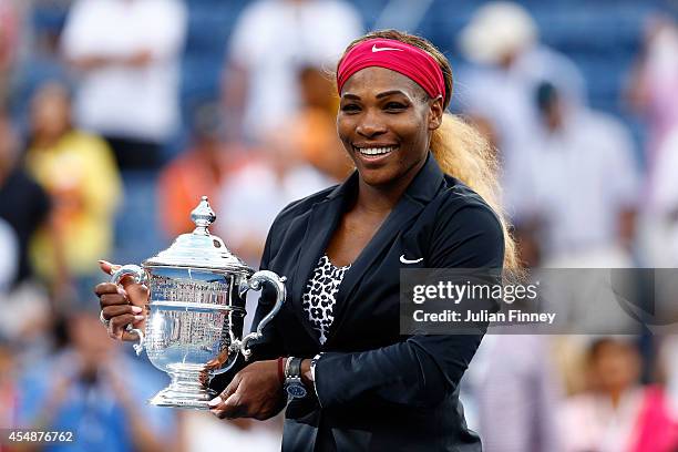 Serena Williams of the United States celebrates with the trophy after defeating Caroline Wozniacki of Denmark to win their women's singles final...