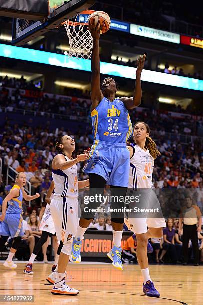 Center Sylvia Fowles of the Chicago Sky lays up the ball against guard Diana Taurasi and center Brittney Griner of the Phoenix Mercury in the second...