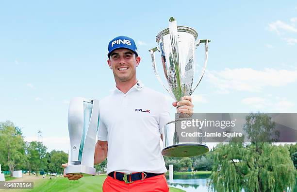 Billy Horschel of the United States poses with the BMW trophy and J.K. Wadley trophy after his two-stroke victory at the of the BMW Championship at...