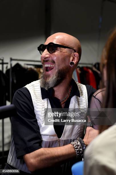 Designer Roberto López Etxeberría prepares backstage at the Etxeberria fashion show during Mercedes-Benz Fashion Week Spring 2015 at The Pavilion at...