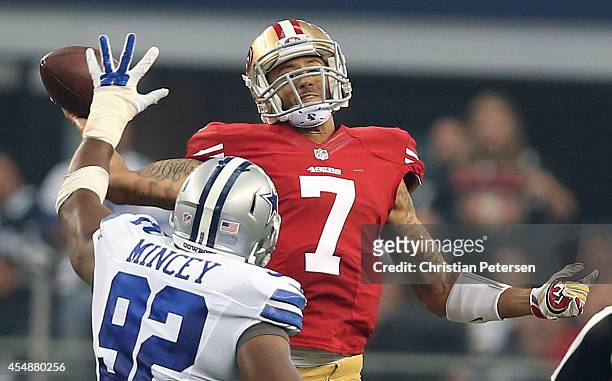 Colin Kaepernick of the San Francisco 49ers gets the pass off under pressure from Jeremy Mincey of the Dallas Cowboys in the first half at AT&T...