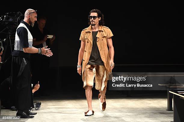 Designer Roberto López Etxeberría watches as a model walks the runway at the Etxeberria fashion show during Mercedes-Benz Fashion Week Spring 2015 at...