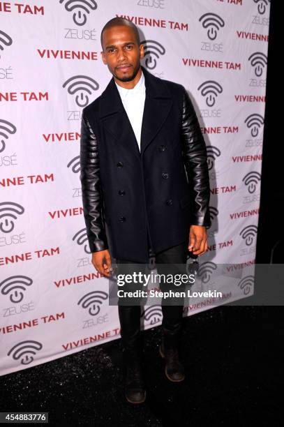 Eric West poses backstage at the Vivienne Tam fashion show during Mercedes-Benz Fashion Week Spring 2015 at The Theatre at Lincoln Center on...