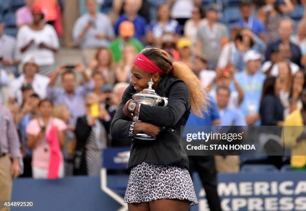 Serena Williams of the US holds the US Open trophy after defeating Caroline Wozniacki of Denmark during their US Open 2014 women's singles finals...