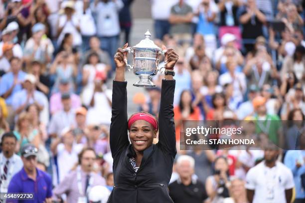 Serena Williams of the US holds the US Open trophy after defeating Caroline Wozniacki of Denmark during their US Open 2014 women's singles finals...