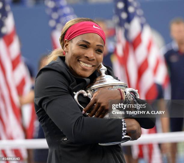 Serena Williams of the US holds the US Open trophy after defeating Caroline Wozniacki of Denmark during their US Open 2014 women's singles finals...