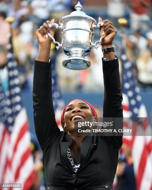 Serena Williams of the US holds the US Open trophy after defeating Caroline Wozniacki of Denmark during their US Open 2014 women's singles finals...