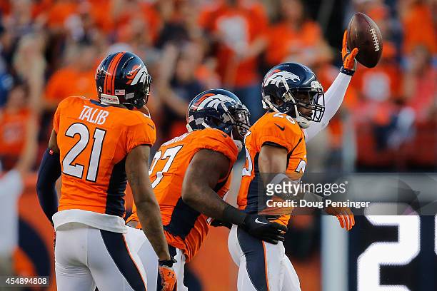 Free safety Rahim Moore of the Denver Broncos celebrates his interception against the Indianapolis Colts with teammates cornerback Aqib Talib and...