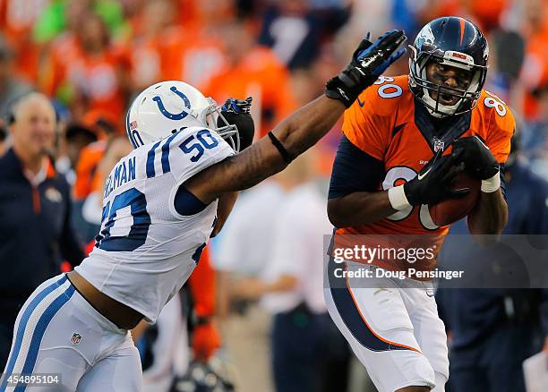 Tight end Julius Thomas of the Denver Broncos makes a 34 yard pass reception against inside linebacker Jerrell Freeman of the Indianapolis Colts for...