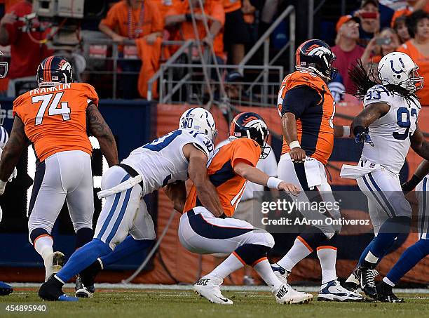 Peyton Manning of the Denver Broncos is taken down by LaRon Landry of the Indianapolis Colts in the first quarter. The Denver Broncos played the...