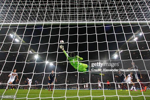 Thomas Mueller of Germany scores their first goal with a header past goalkeeper David Marshall of Scotland during the EURO 2016 Group D qualifying...