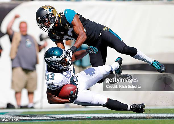 Darren Sproles of the Philadelphia Eagles is tackled in the end zone by Alan Ball of the Jacksonville Jaguars on a 49-yard touchdown during the third...