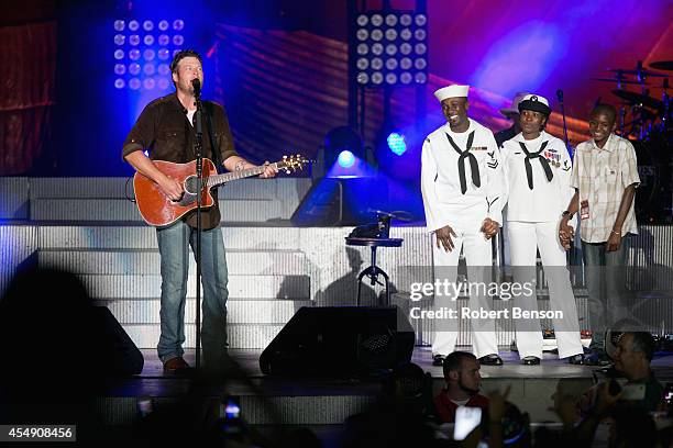 Blake Shelton and JCPenney honor a military USO family, Roland Kiendrebeogo, his wife Marie Esther Kiendrebeogo and their son Oswald Kiendrebeogo ,...