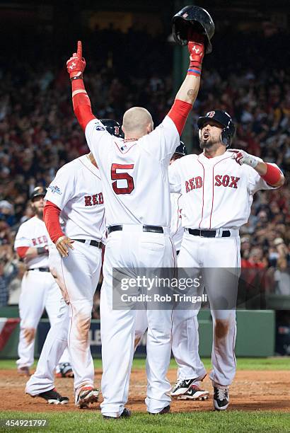 Shane Victorino of the Boston Red Sox celebrates with his teammates after hitting a grand slam home run in the seventh inning against the Detroit...