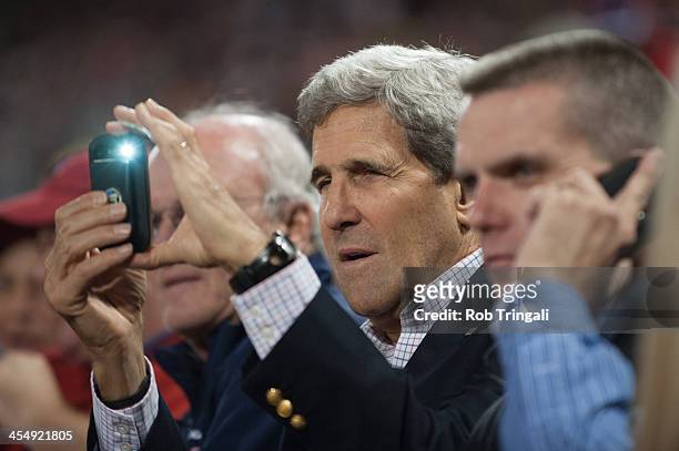 Secretary of State John Kerry takes photos during Game Six of the American League Championship Series between the Boston Red Sox the Detroit Tigers...