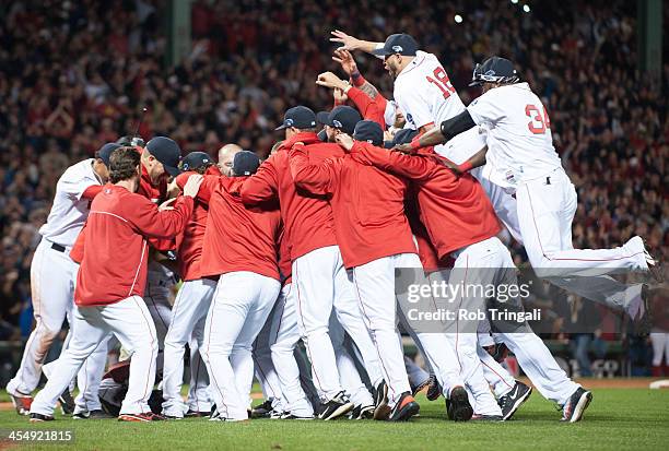 The Boston Red Sox celebrate after defeating the Detroit Tigers during Game Six of the American League Championship Series on October 19, 2013 at...