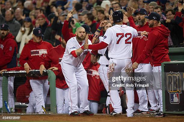 Xander Bogaerts of the Boston Red Sox is congratulated by teammates as he enters the dugout during Game Six of the American League Championship...
