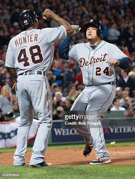 Torii Hunter and Miguel Cabrera of the Detroit Tigers celebrate after scoring in the top of the sixth inning during Game Six of the American League...