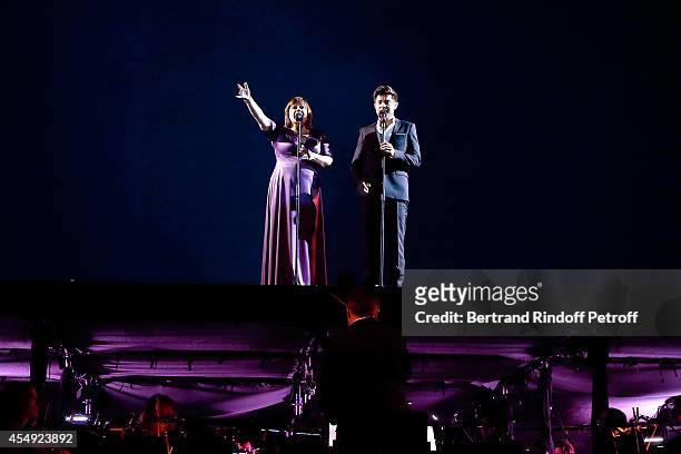 Singers Lisa Angell and Vincent Niclo perform during the 'Claude Lelouch en Musique ! Held at the Invalides in Paris on September 6, 2014 in Paris,...