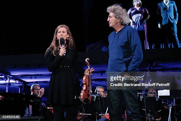 Violonist Anne Gravoin and stage director Elie Chouraqui on stage at the end of the 'Claude Lelouch en Musique ! Held at the Invalides in Paris on...