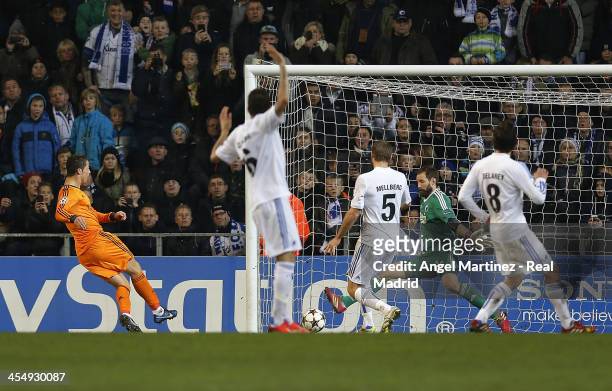 Cristiano Ronaldo of Real Madrid scores his team's second goal past goalkeeper Johan Wiland of FC Copenhagen during the UEFA Champions League Group B...
