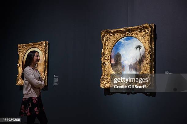 Woman views a painting by J.M.W. Turner entitled 'Dawn of Christianity' in a new exhibition at the Tate Britain gallery entitled 'Late Turner -...