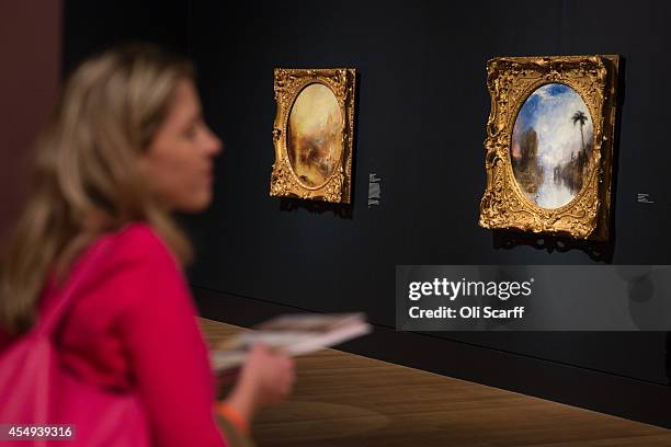 Woman views a painting by J.M.W. Turner entitled 'Dawn of Christianity' in a new exhibition at the Tate Britain gallery entitled 'Late Turner -...