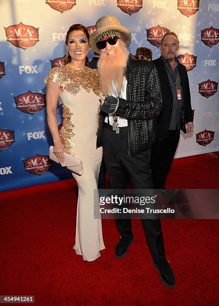Musician Billy Gibbons of ZZ Top and wife Gilligan Stillwater arrive at the American Country Awards 2013 at the Mandalay Bay Events Center on...