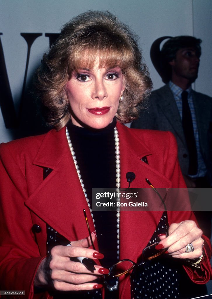 Joan Rivers autographs copies of her comedy album "What Becomes a Semi-Legend Most?"