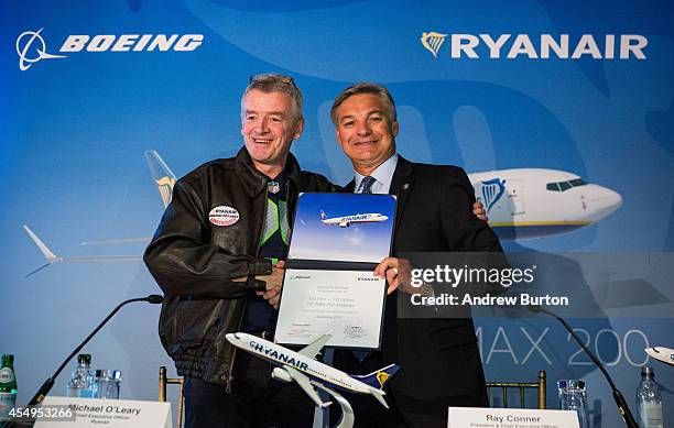 Michael O'Leary, CEO of Ryanair and Ray Conner, President and CEO of The Boeing Company, shake hands after signing a contract announcing the first...