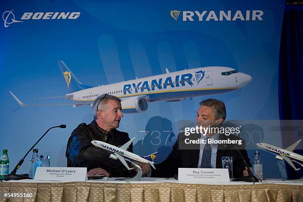 Michael O'Leary, chief executive officer of Ryanair Holdings Plc, left, shakes hands with Ray Conner, chief executive officer of Boeing Commercial...