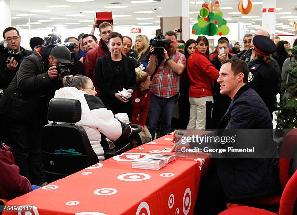 Professional hockey player Dion Phaneuf signs autographs during an in-store Holiday appearance at Target at Shoppers World Danforth on December 10,...