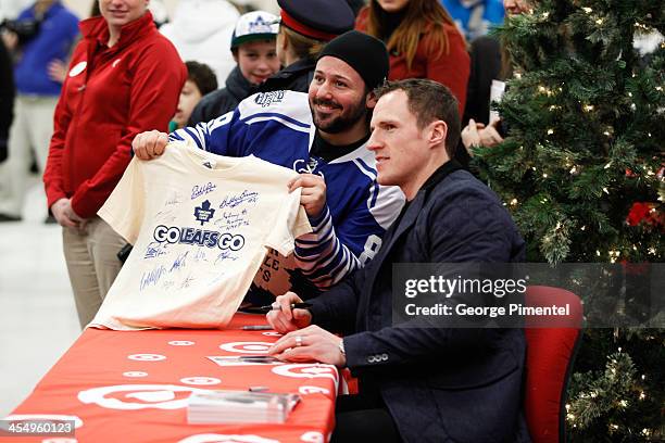 Professional hockey player Dion Phaneuf signs autographs during an in-store Holiday appearance at Target at Shoppers World Danforth on December 10,...