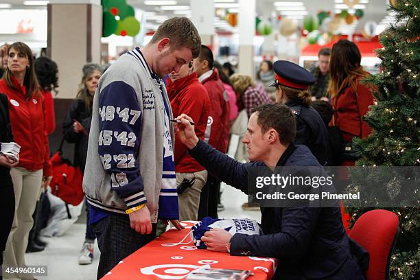 Professional hockey player Dion Phaneuf signs autographs during an in-store Holiday appearance at Target at Shoppers World Danforth on December 10,...