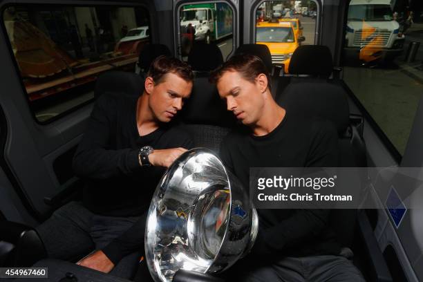 Bob Bryan and Mike Bryan of United States look at the US Open men's doubles champions trophy during their New York City media tour after winning...