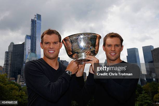 Bob Bryan and Mike Bryan of United States pose with the US Open men's doubles champions trophy in Central Park during their New York City media tour...