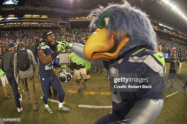 Seattle Seahawks Richard Sherman with mascot Blitz after winning game vs Green Bay Packers at CenturyLink Field. Seattle, WA 9/4/2014 CREDIT: Robert...