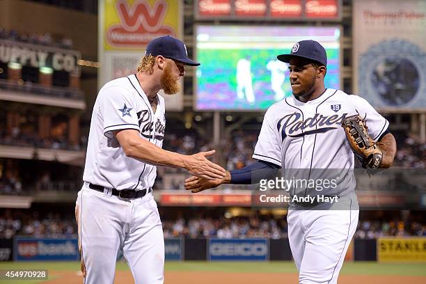 Rymer Liriano is congratulated by Andrew Cashner of the San Diego Padres after making a catch on a ball hit by Dee Gordon of the Los Angeles Dodgers...