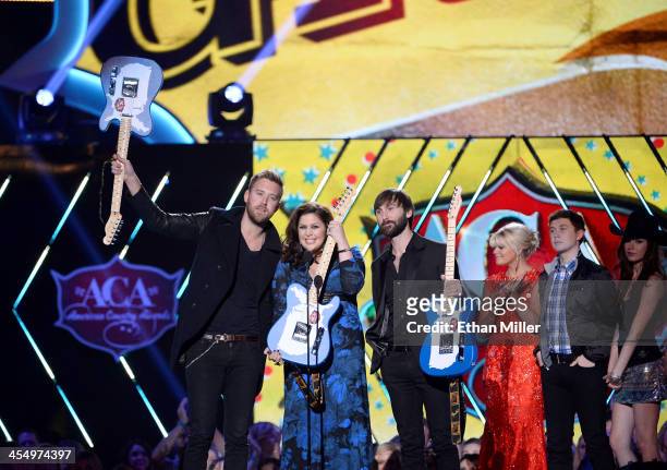 Recording artists Charles Kelley, Hillary Scott and Dave Haywood of Lady Antebellum accept the award for Group of the Year from presenters Lauren...