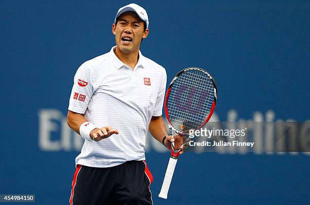 Kei Nishikori of Japan reacts against Marin Cilic of Croatia during their men's singles final match on Day fifteen of the 2014 US Open at the USTA...