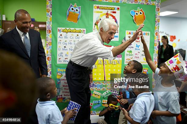 Former Florida Governor and current Democratic Party candidate for Governor, Charlie Crist and Massachusetts Governor Deval Patrick greet children...