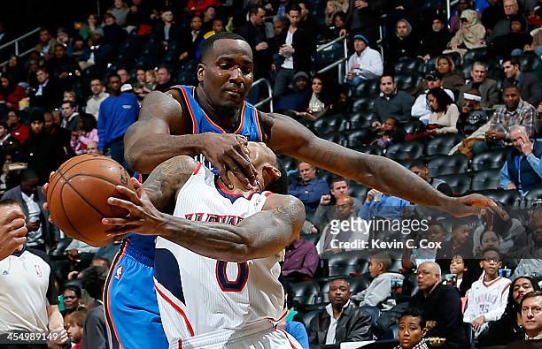 Jeff Teague of the Atlanta Hawks draws a flagrant foul from Kendrick Perkins of the Oklahoma City Thunder at Philips Arena on December 10, 2013 in...