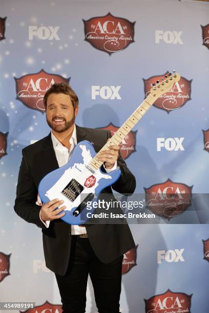 Recording artist Randy Houser poses with the award for Most Played Radio Track in the press room during the American Country Awards 2013 at the...