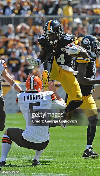 Punt returner Antonio Brown of the Pittsburgh Steelers attempts to hurdle punter Spencer Lanning of the Cleveland Browns during a game at Heinz Field...