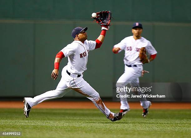 Yoenis Cespedes of the Boston Red Sox misplays a fly ball against the Baltimore Orioles during the game at Fenway Park on September 8, 2014 in...